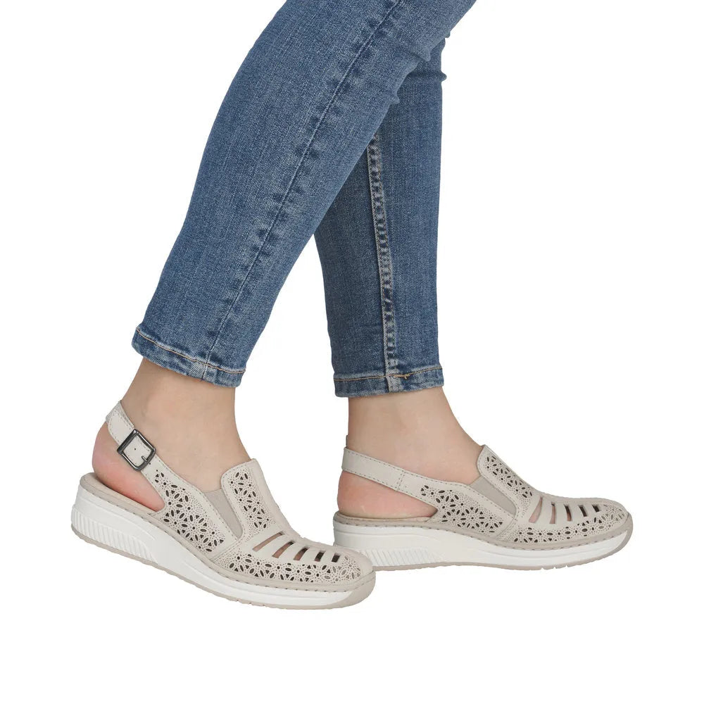 Rieker 48763-60 women's cream leather sling back sandals with cutout design and adjustable strap.