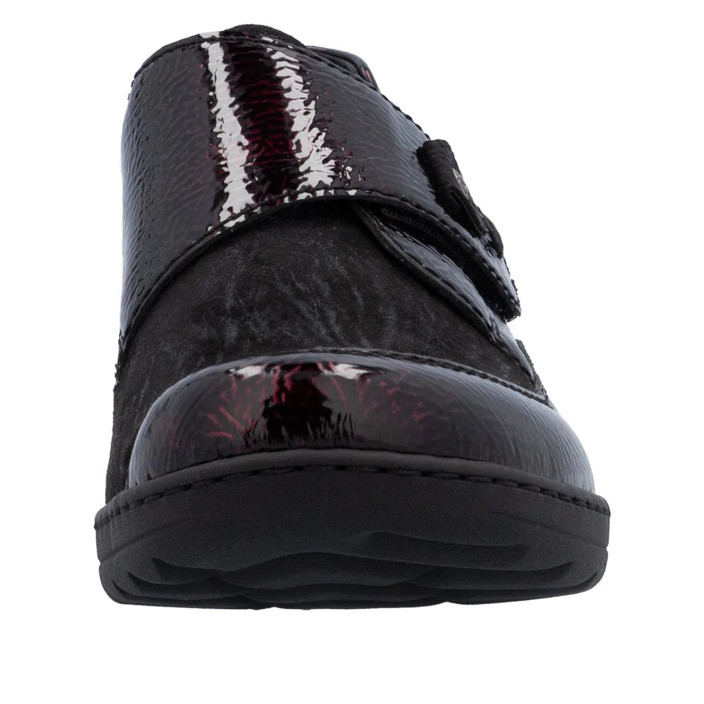 Rieker 48951-35 women's red touch fastening shoes with shiny patent and matte black panels, cushioned sole, and slip-on design.