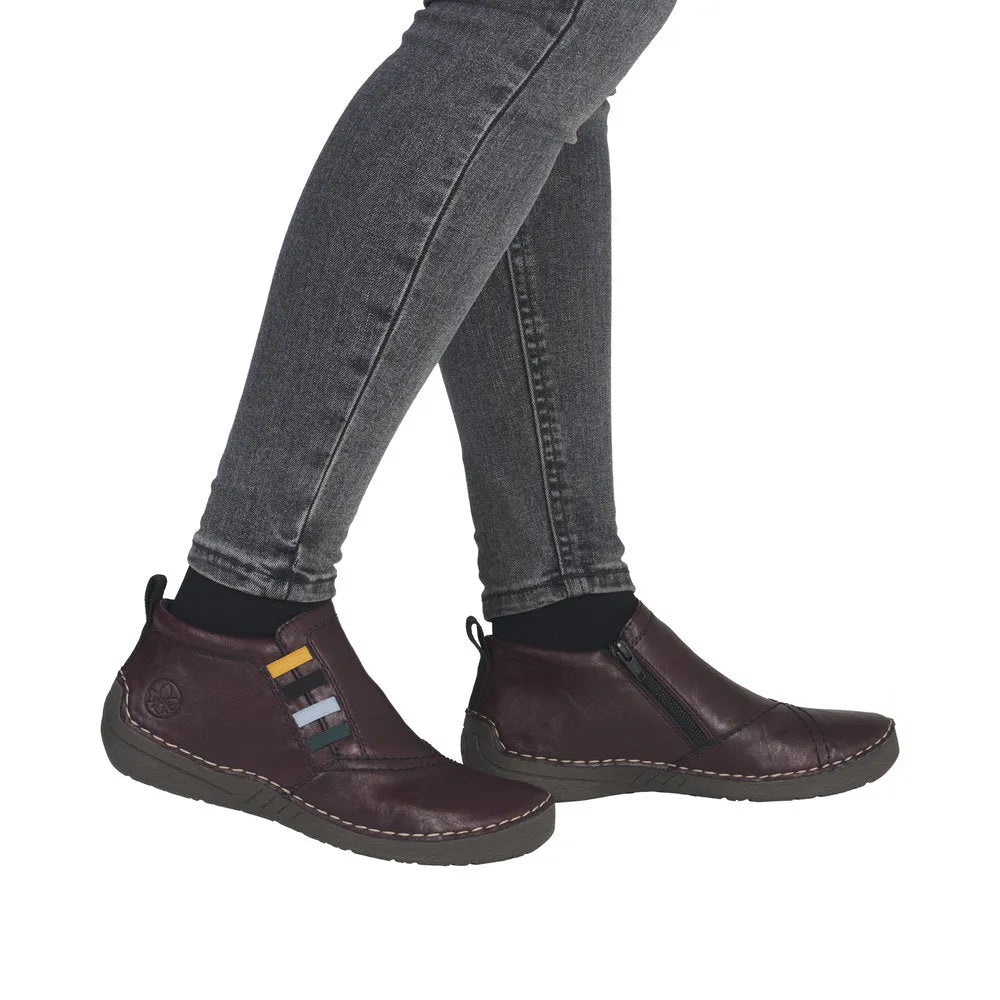 Rieker 52584-30 women's red ankle boots with side zipper, leather upper, and slip-on design.
