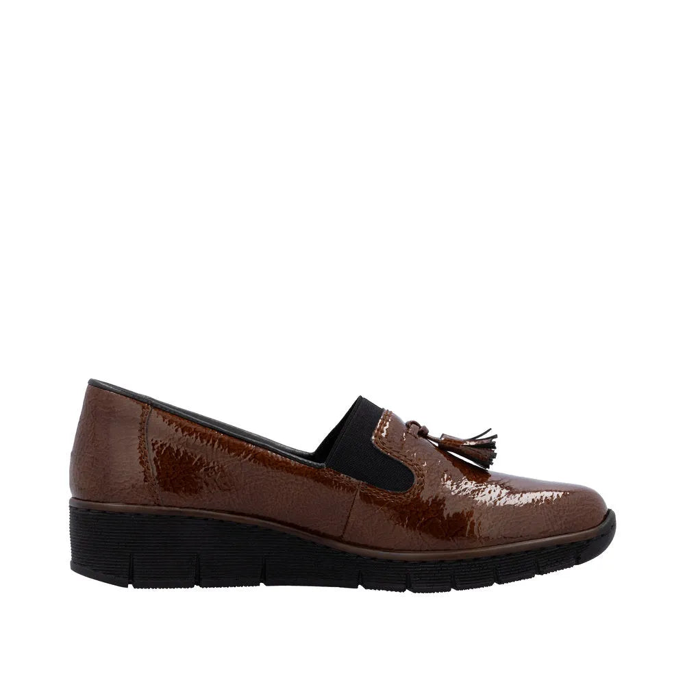 Rieker 53751-24 women's brown slip-on shoes with tassel detail and elastic side panels, comfortable flat sole.