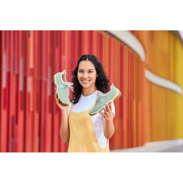 Woman holding mint lace-up Rieker 55950-52 shoes, casual style, materials, and color details visible.