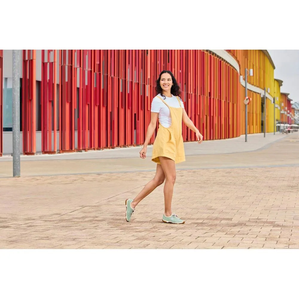 Rieker 55950-52 mint lace-up shoes, casual style, with textured material, on a woman in a white top and yellow dress.