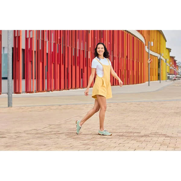 Rieker 55950-52 mint lace-up shoes, casual style, with textured material, on a woman in a white top and yellow dress.