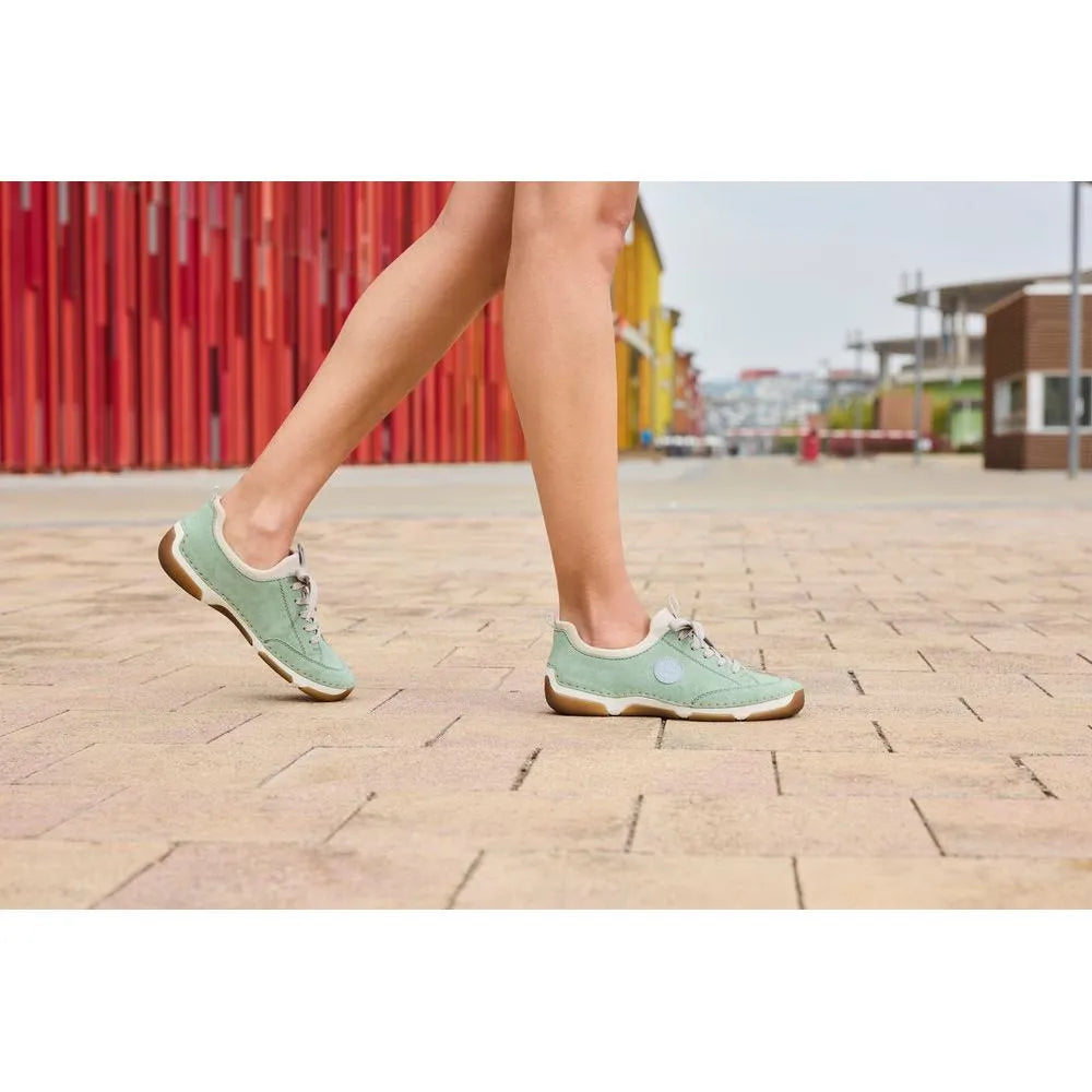Rieker 55950-52 mint lace-up casual shoes with beige accents and rubber sole, worn by a person walking outdoors.