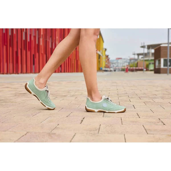Rieker 55950-52 mint lace-up casual shoes with beige accents and rubber sole, worn by a person walking outdoors.