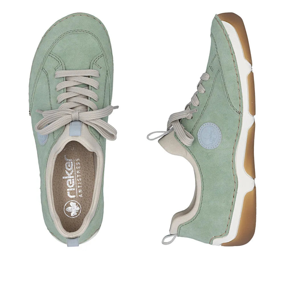 Mint green lace-up sneakers with beige accents, cushioned sole, and breathable interior for Ladies.