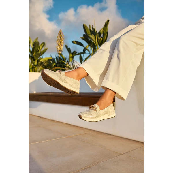 Rieker 58944-61 beige slip-on shoes with bow detail, cushioned sole, lightweight design, and comfortable fit for women.