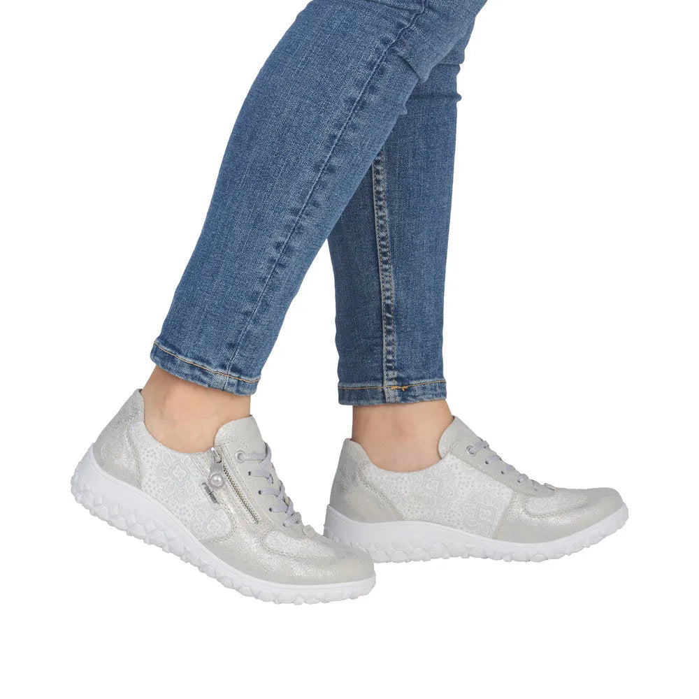 Rieker 59501-90 women's wide white shoes with silver accents, lace-up style, textured materials, and side zipper detail.