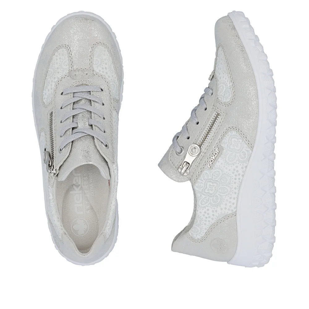 Rieker 59501-90 women's wide white/silver ankle shoes with lace-up and zipper details, textured materials, and chunky white soles.