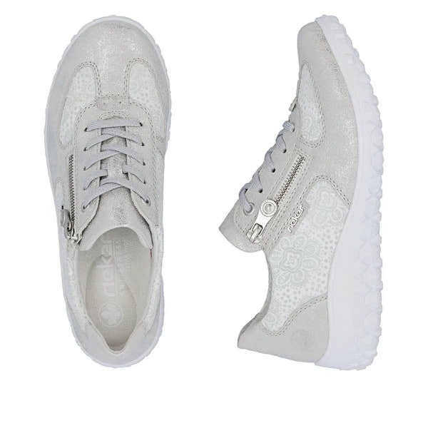 Rieker 59501-90 women's wide white/silver ankle shoes with lace-up and zipper details, textured materials, and chunky white soles.