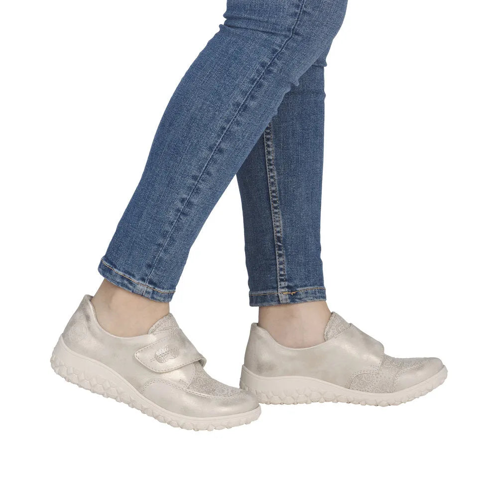 Cream wide-touch fastening shoes with textured material, chunky sole, and ergonomic design.