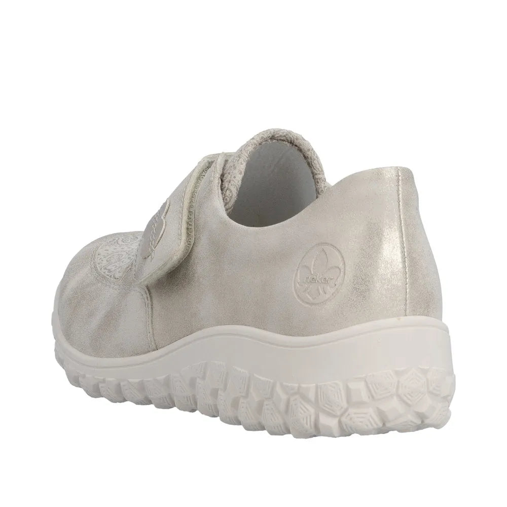 Cream touch-fastening wide-fit ladies' shoes with textured sole and embossed logo, made of smooth material.