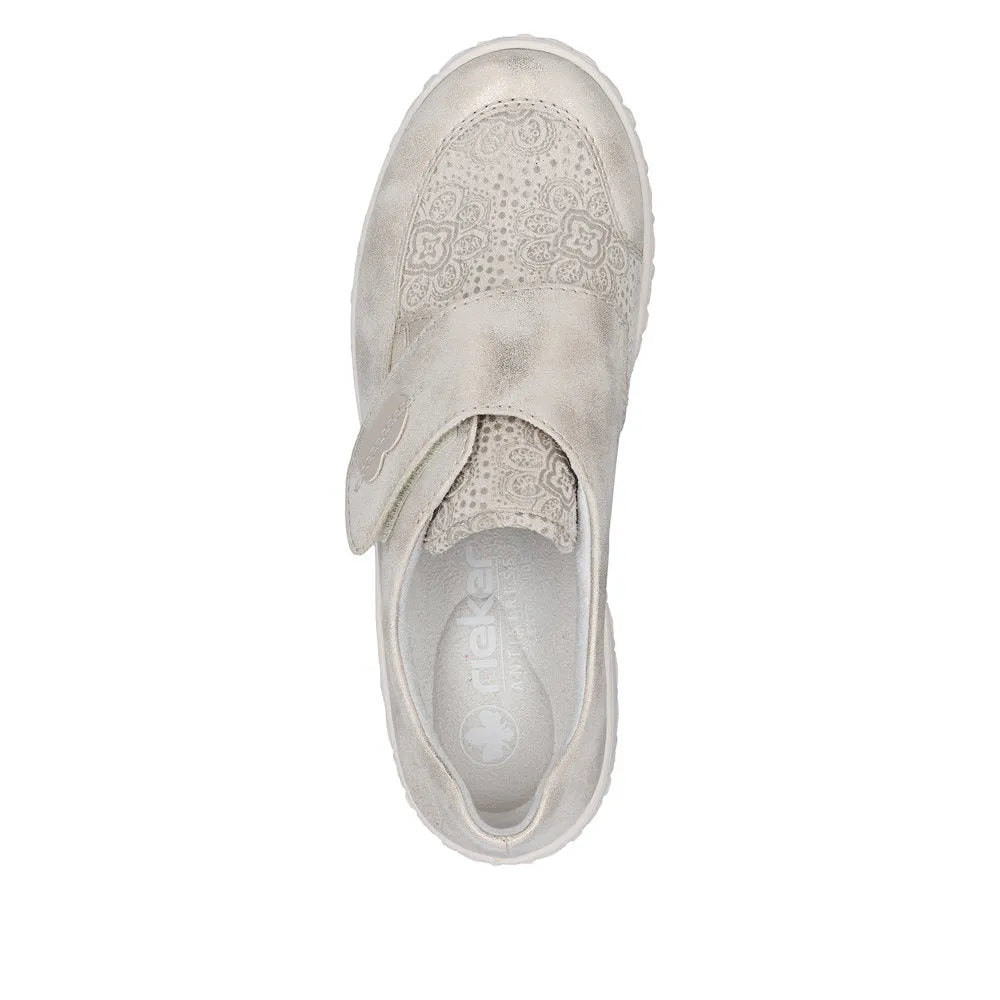 Cream wide-fit ladies shoes with touch-fastening strap, perforated floral design, and suede-like material from Rieker 59552-62.