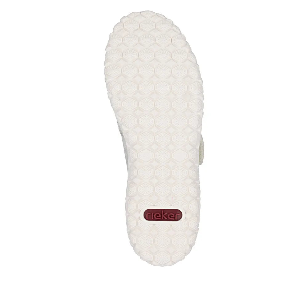 Cream wide-fit ladies shoes with touch fastening, cushioned sole, textured grip, and Rieker logo on bottom.