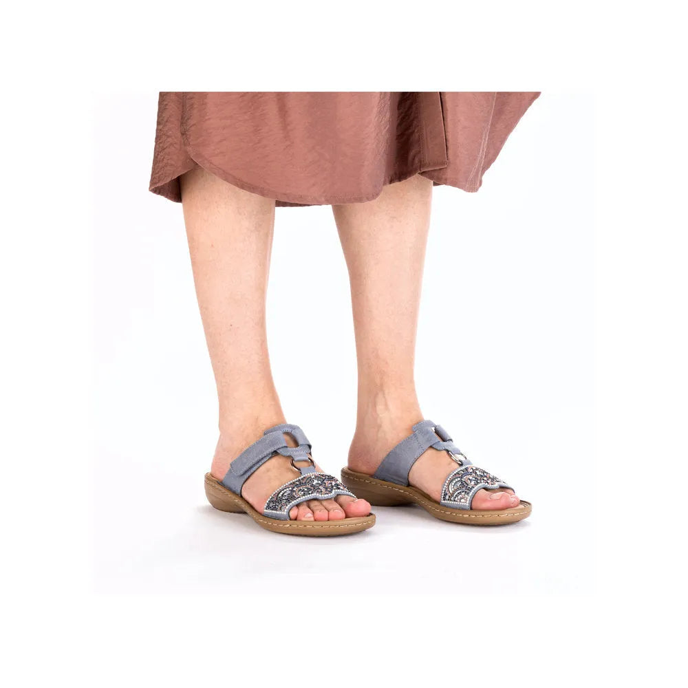 Rieker 608K2-12 ladies blue touch fastening mules with decorative embellishments and open-toe design.