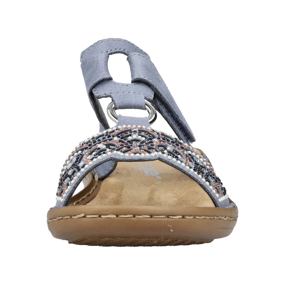 Rieker 608K2-12 women's blue touch fastening mules with beaded embellishments, open toe, cushioned footbed, and flat sole.