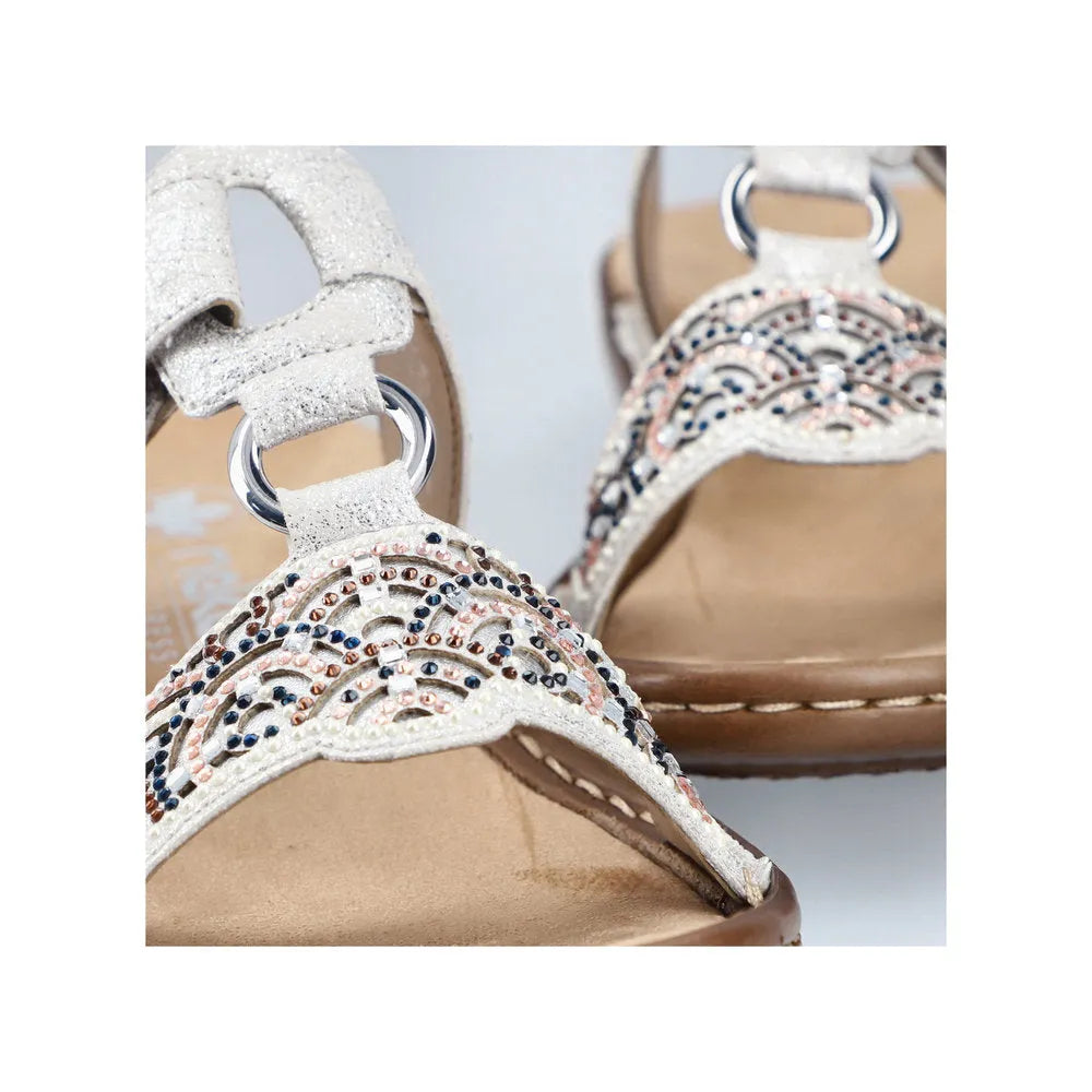 Rieker 608K2-40 women's silver touch fastening open-toe mules with embellished straps and beige insole.