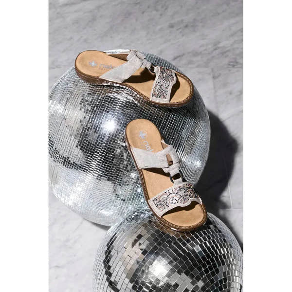 Rieker 608K2-40 women's silver touch fastening mules on disco balls, stylish slip-on sandals with decorative cutouts and embellishments.