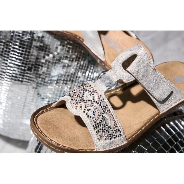 Rieker 608K2-40 ladies silver touch fastening mules with decorative embellishments and cushioned sole.