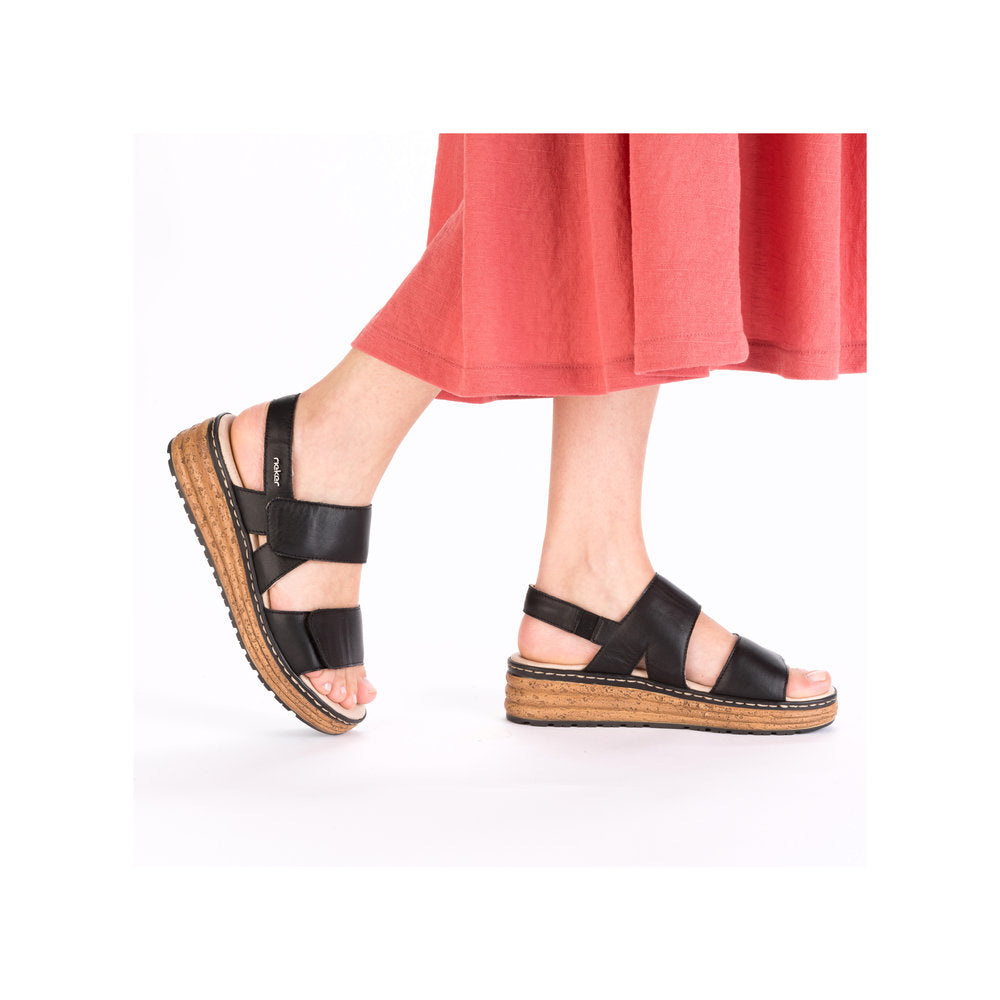 Rieker 62761-00 ladies black leather touch fastening sandals with cork wedge sole and open toe design.