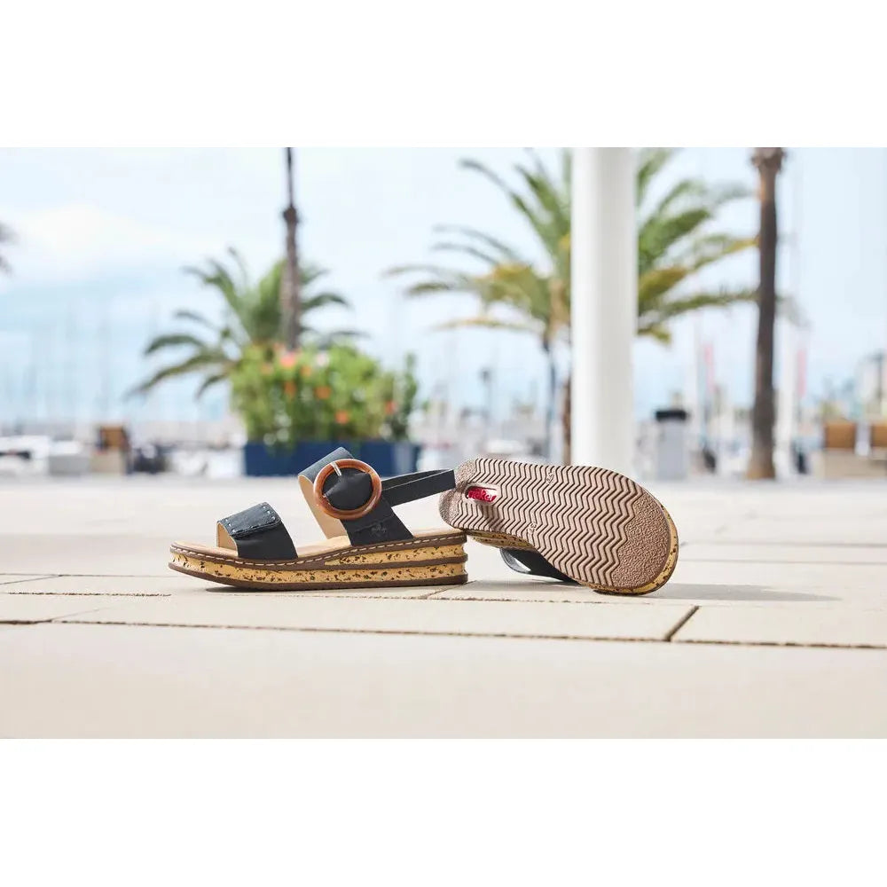 Rieker 62950-14 Ladies Pacific Blue Touch Fastening Sandals on wooden deck with palm trees and marina background.