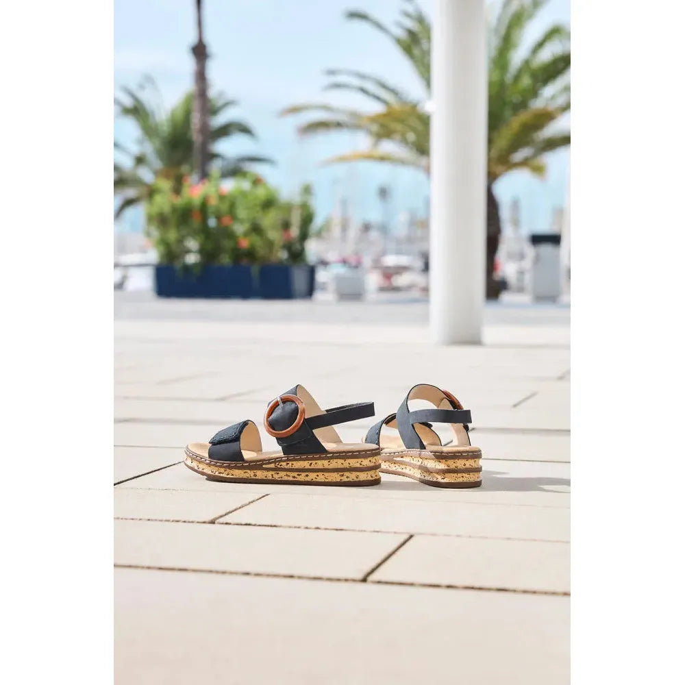 Rieker 62950-14 Ladies Pacific Blue Touch Fastening Sandals on a outdoor tiled surface with palm trees in background.