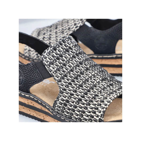 Rieker 62971-00 women's black textile elasticated sandals with cork wedge sole and slip-on design.