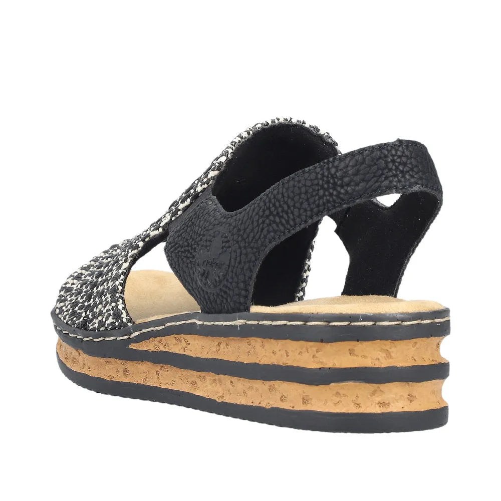 Rieker 62971-00 women's black textile elasticated sandals with layered cork and rubber sole, stylish open-toe design.