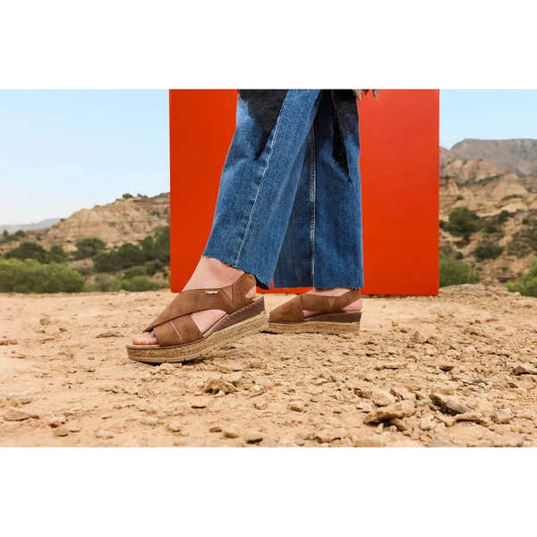 Rieker 63782-24 women's brown elasticated slip-on sandals, with cushioned sole, outdoor desert landscape background.