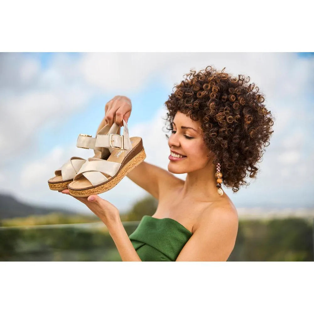 Rieker 63795-60 ladies muschel buckle beige sandals, open toe, ankle strap, platform wedge heel, outdoor setting.