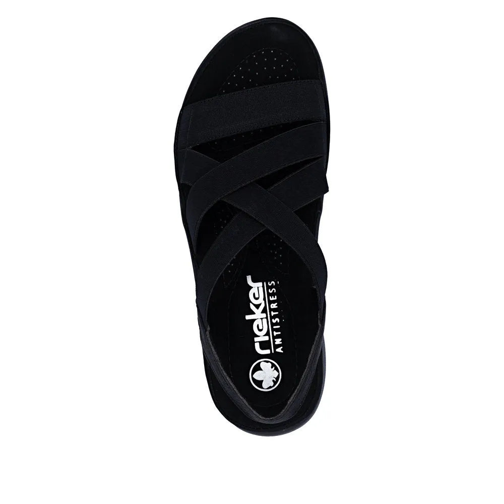 Rieker 64857-00 women's black elasticated slip-on sandals with crisscross straps and cushioned footbed.