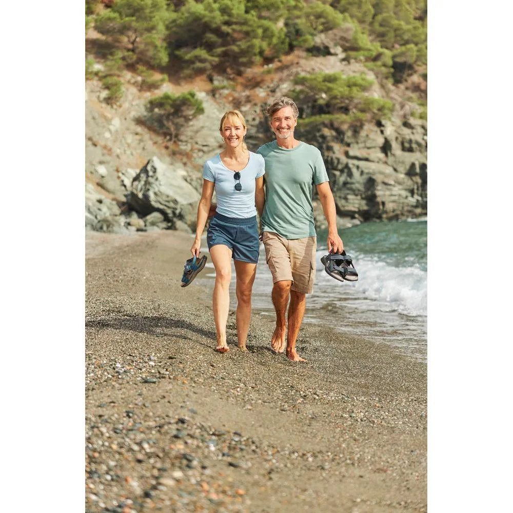 Rieker 64870-14 Ladies BlueTouch fastening sandals, navy/jeans blue, on a woman at the seaside with a man.