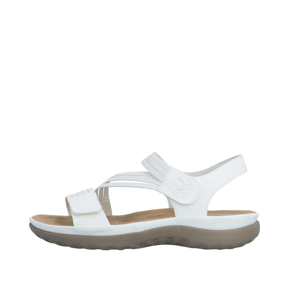 White slip-on women's sandals with adjustable touch-fastening straps, cushioned footbed, and a beige rubber sole.