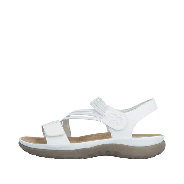 White slip-on women's sandals with adjustable touch-fastening straps, cushioned footbed, and a beige rubber sole.
