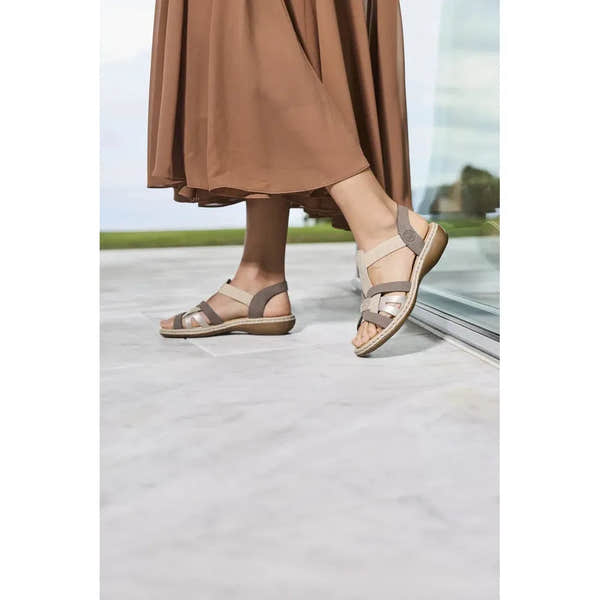 Rieker 65918-64 ladies grey and champagne elasticated summer sandals worn with a brown skirt.