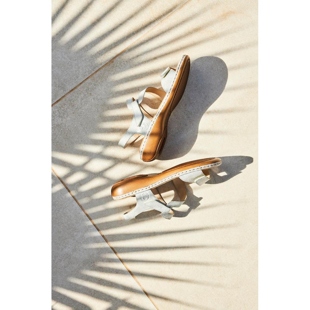 Rieker 659C7-93 ladies silver leather touch fastening sandals with cushioned insoles and tan soles, placed on a tiled surface with shadow pattern.