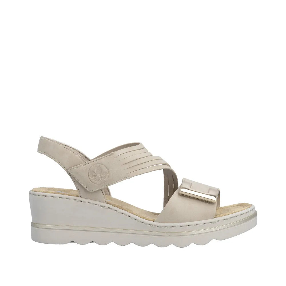 Rieker 67410-62 beige women's touch fastening sandals with wedge heel, adjustable straps, and metallic buckle detail.