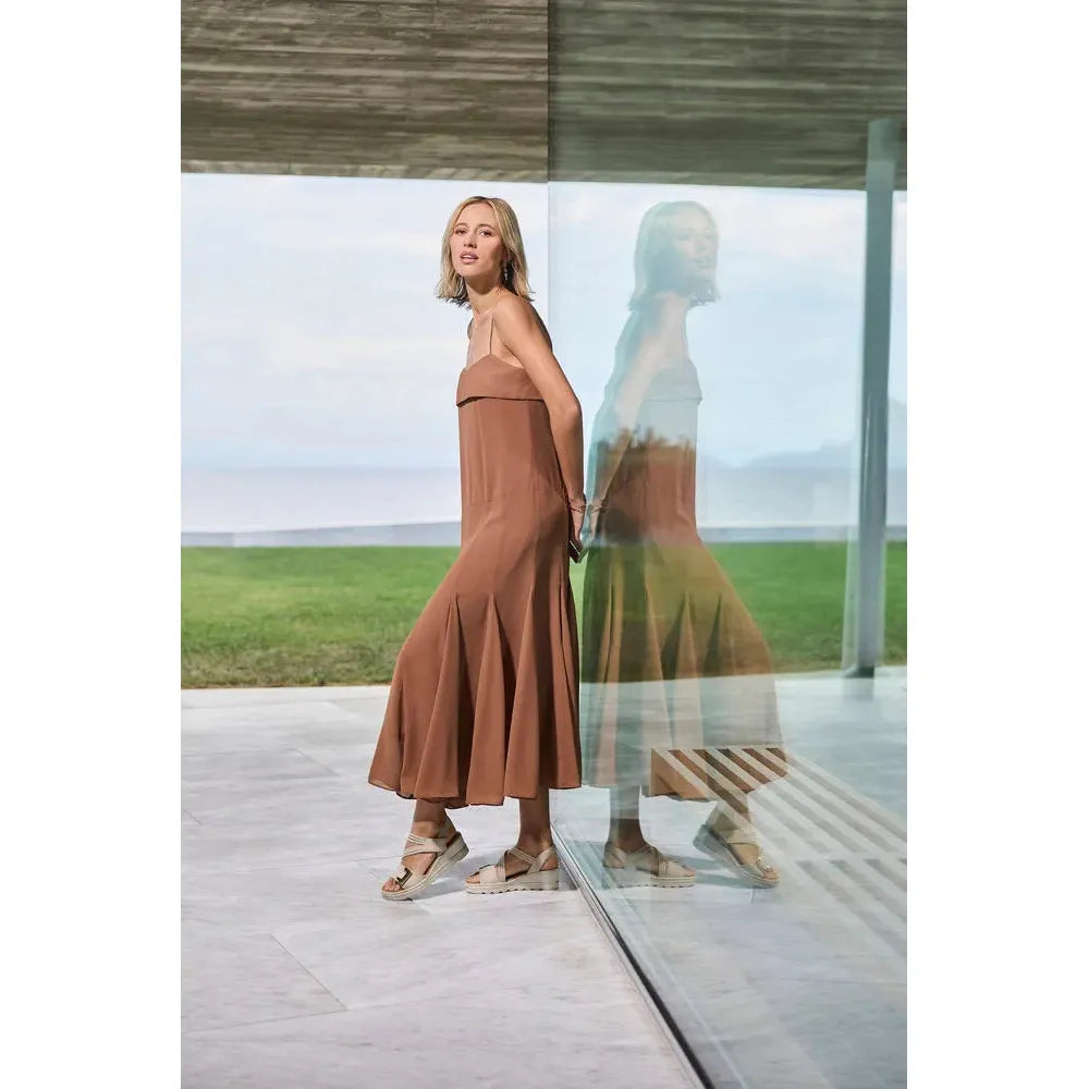 Rieker 67410-62 beige touch fastening women's sandals with chunky heel, worn by a woman in a brown maxi dress, outside by a glass wall.