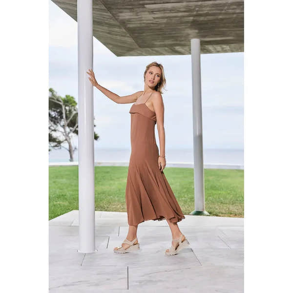 Rieker 67410-62 beige touch fastening ladies' sandals worn by a woman in a brown dress outdoors near the ocean.