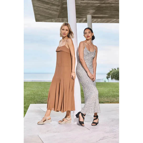 Rieker 67410-62 beige touch fastening sandals worn by models in a fashionable outdoor setting.