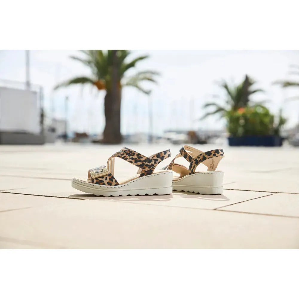 Rieker 67410-90 women's animal print touch-fastening wedge sandals with leopard design and white sole.