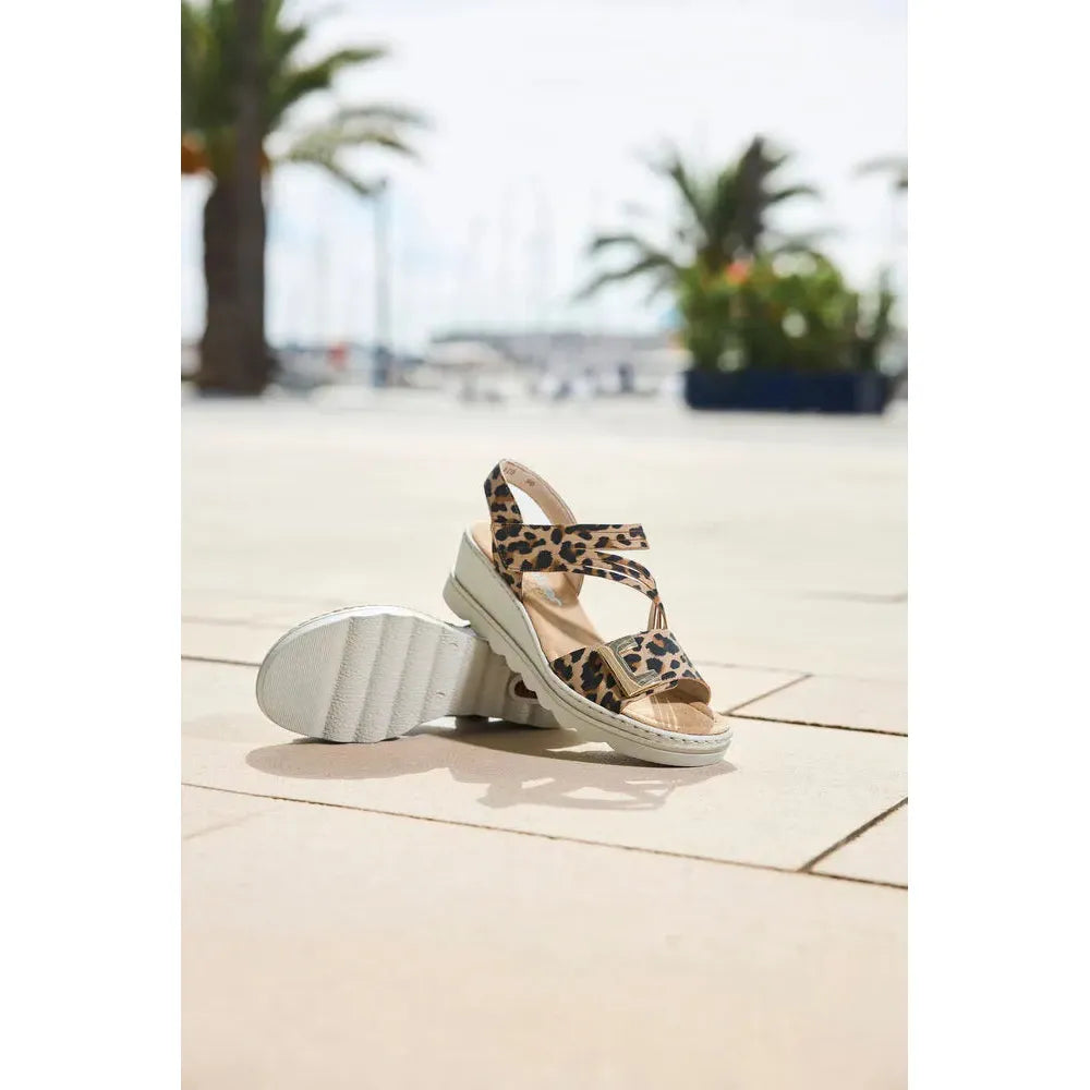 Rieker 67410-90 women's animal print touch fastening sandals with leopard pattern and chunky white sole.