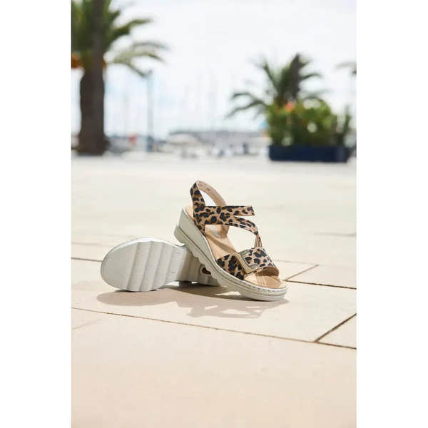 Rieker 67410-90 women's animal print touch fastening sandals with leopard pattern and chunky white sole.
