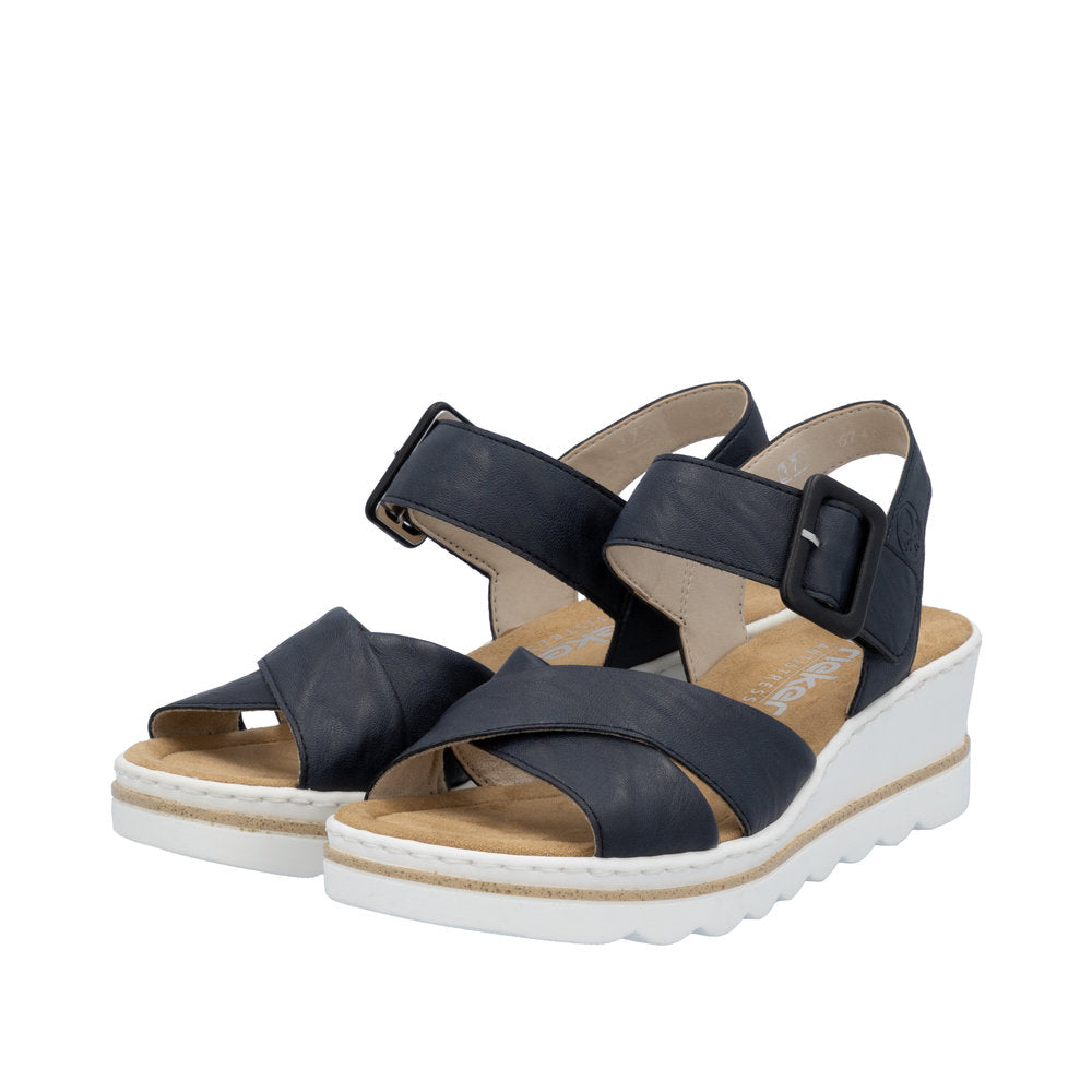 Rieker 67463-14 women's navy blue buckle sandals with cushioned insole and white wedge sole.