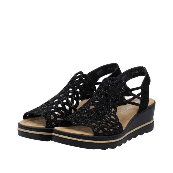 Rieker 67465-00 women's black textile elasticated open-toe sandals with intricate cutout design and wedge heel.