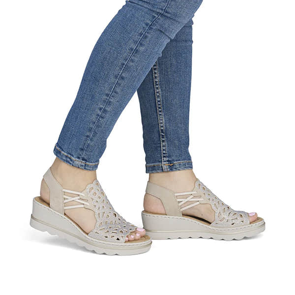 Rieker 67465-62 beige ladies elasticated sandals with cutout design and chunky sole, ideal for casual summer wear.