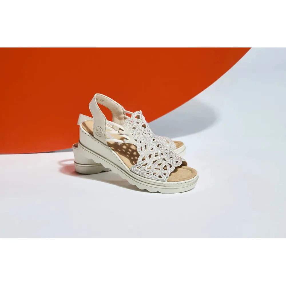 Rieker 67465-62 beige women's elasticated sandals with intricate cut-out design and cushioned sole.