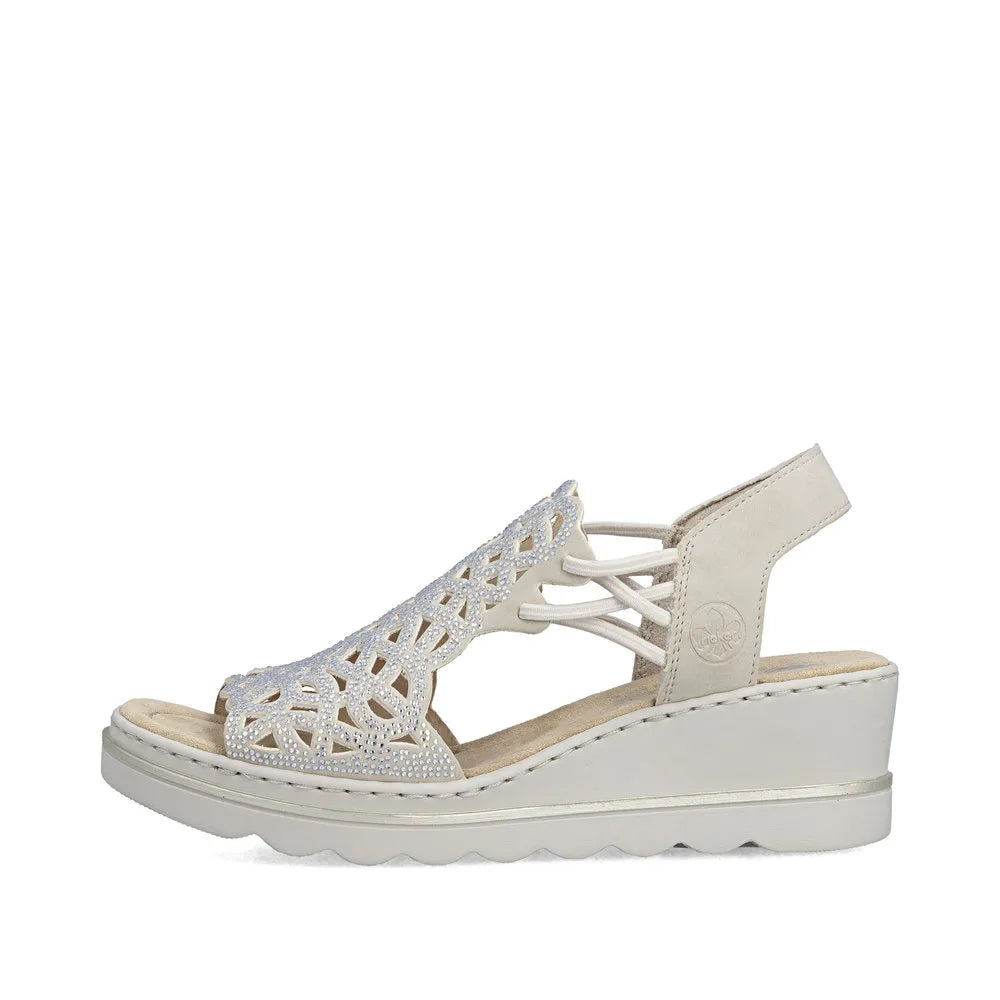 Rieker 67465-62 beige ladies elasticated open-toe wedge sandals with intricate cut-out design and adjustable heel strap.