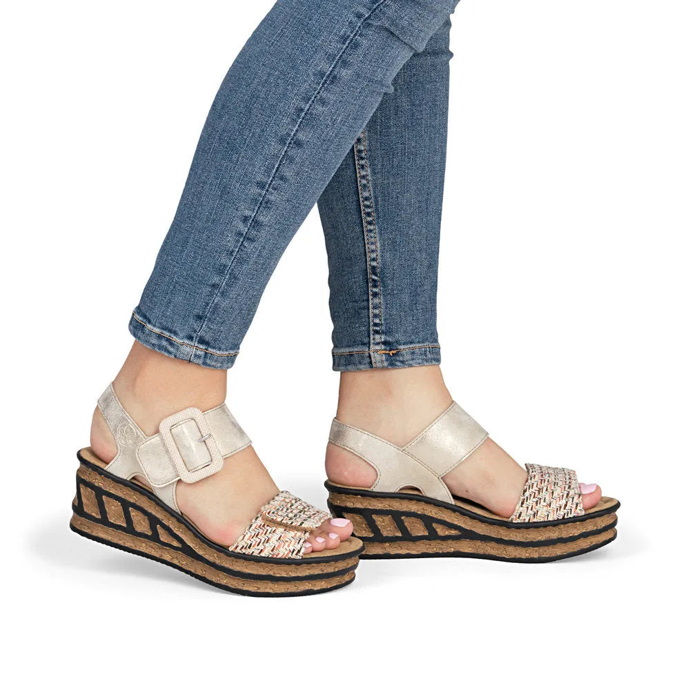 Rieker 68172-60 beige touch fastening woven platform sandals with cork and black striped soles.
