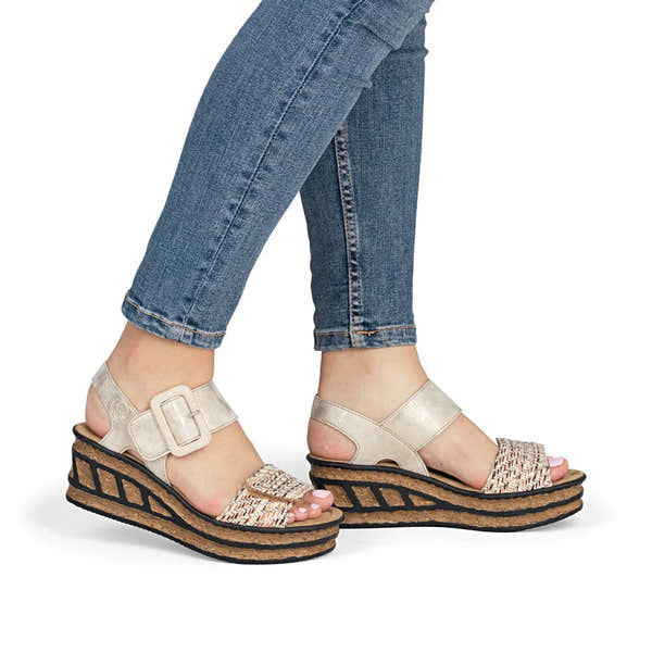 Rieker 68172-60 beige touch fastening woven platform sandals with cork and black striped soles.